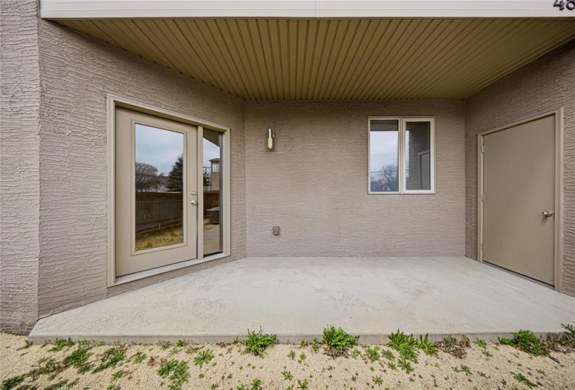 Covered balcony area has door leading to storage room