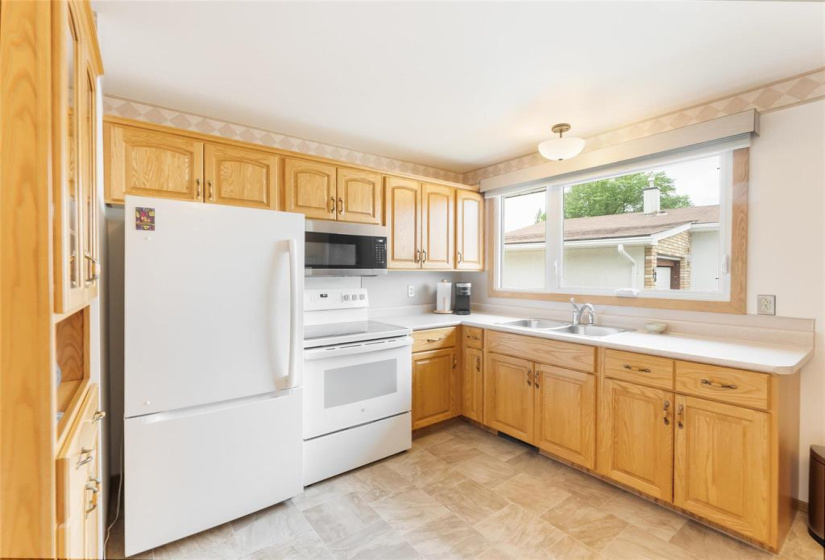 Oak cabinets. Newer fridge and stove, microwave hood fan included. Double sinks. China cabinet excluded