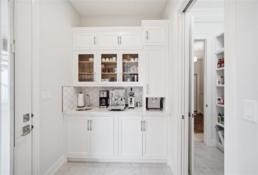 Dedicated espresso bar leading to walk in pantry and covered deck bbq area