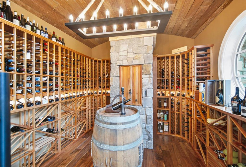 Custom cedar lined Genuwine cellar with dumbwaiter to custom commercial grade wine making room in lower level