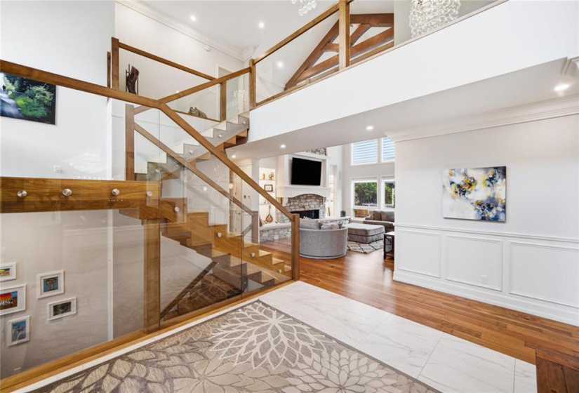 Floating walnut staircase with glass railings