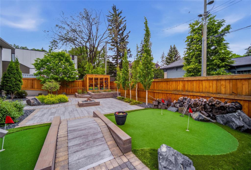 Award winning landscape design by Silverstone, putting green, greenhouse, gas fire pit