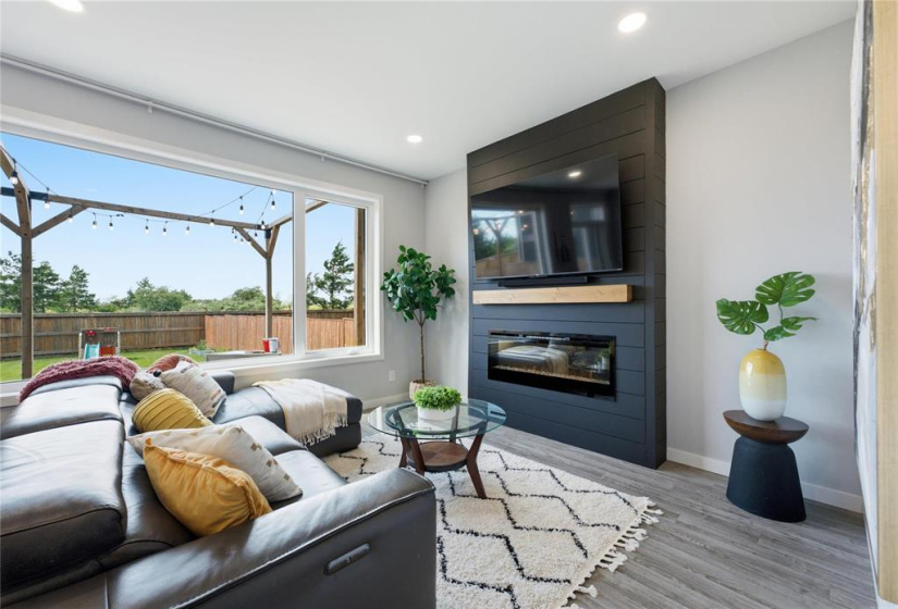 Featurewall with electric fireplace and hidden added shelving.